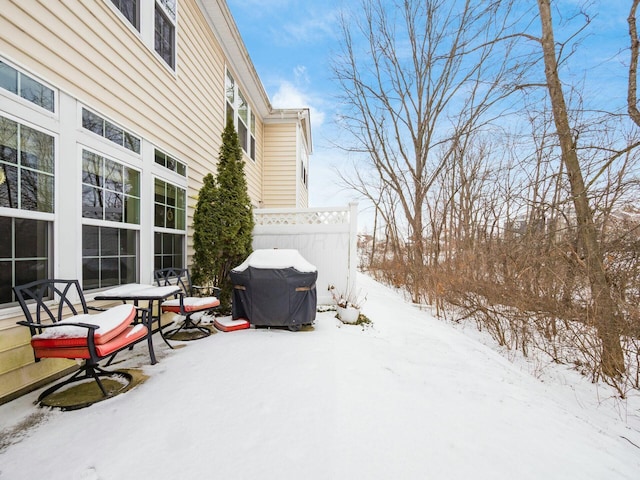 yard layered in snow with fence