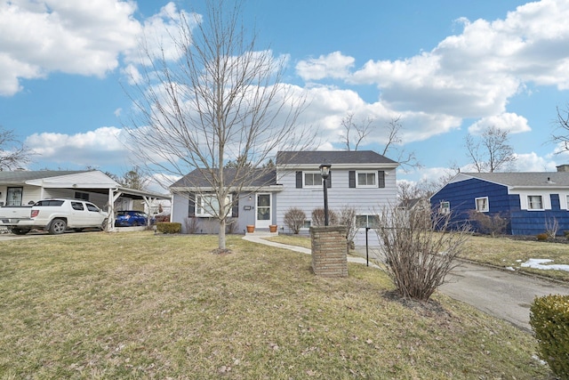 tri-level home featuring entry steps, a carport, and a front yard