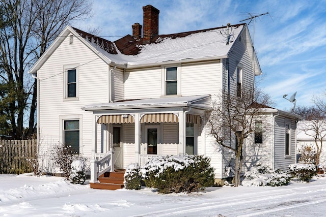 view of front of property with a chimney and a porch