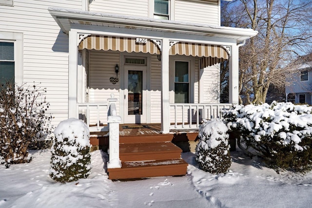 view of snow covered property entrance