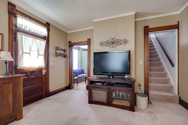 living room featuring light carpet, baseboards, stairs, and ornamental molding