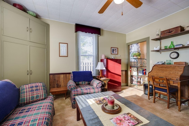 sitting room featuring a ceiling fan and light carpet