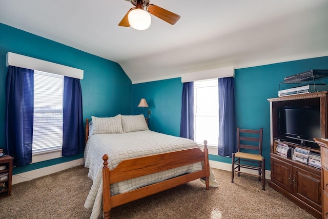 carpeted bedroom with vaulted ceiling and ceiling fan