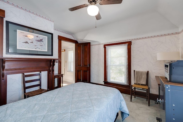 carpeted bedroom with vaulted ceiling and ceiling fan