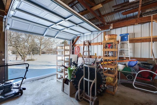 snow covered garage featuring metal wall