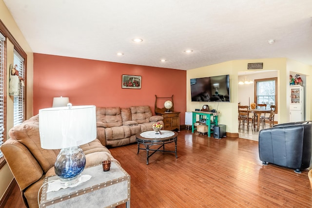 living room with recessed lighting, wood finished floors, an inviting chandelier, and baseboards