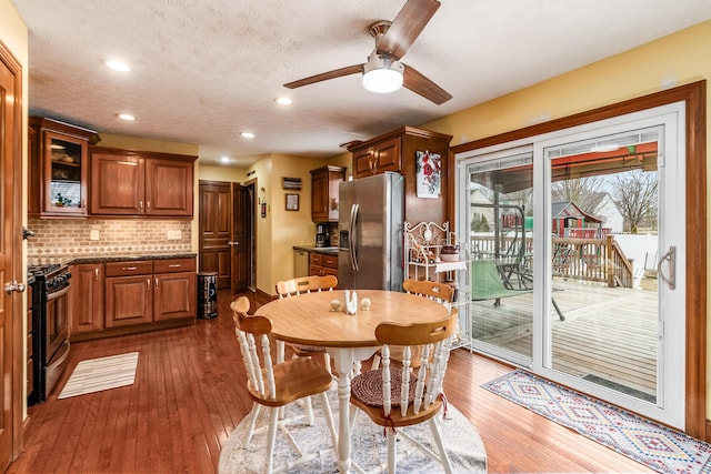 dining room featuring dark wood-style floors, ceiling fan, a textured ceiling, and recessed lighting