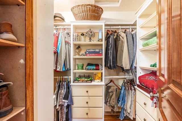 walk in closet with wood finished floors