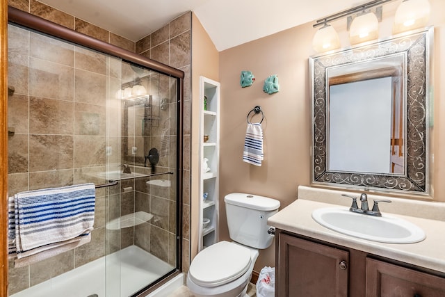 full bathroom featuring toilet, a shower stall, and vanity