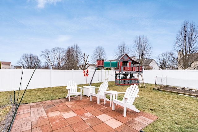 view of patio with a playground and a fenced backyard