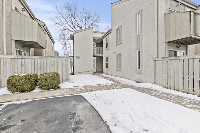 exterior space featuring fence and stucco siding