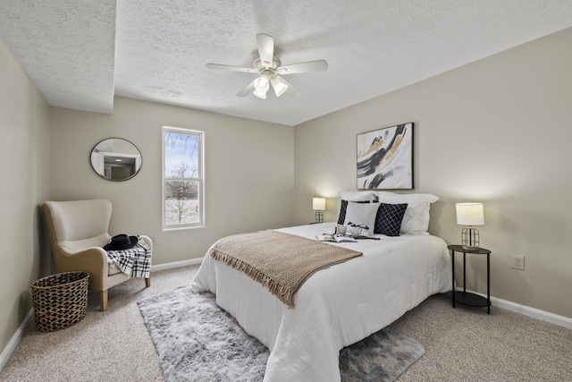 bedroom with a ceiling fan, a textured ceiling, baseboards, and carpet flooring