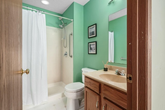 bathroom featuring a textured ceiling, a stall shower, vanity, and toilet