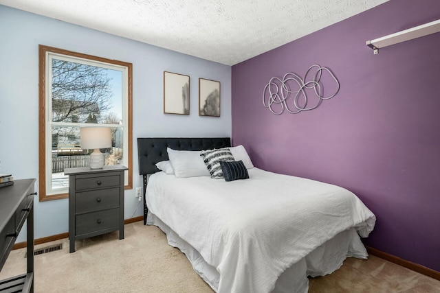 bedroom with visible vents, baseboards, light colored carpet, baseboard heating, and a textured ceiling