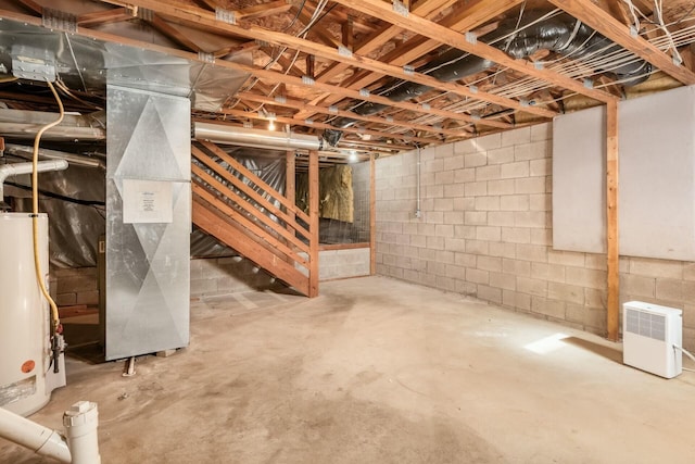 unfinished basement featuring water heater