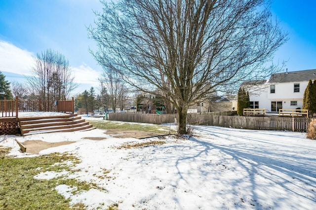 yard covered in snow with fence