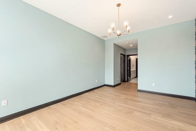 unfurnished room featuring a chandelier, recessed lighting, light wood-type flooring, and baseboards