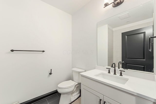 bathroom with vanity, toilet, and tile patterned floors