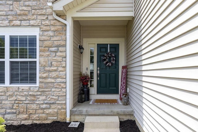 property entrance featuring stone siding