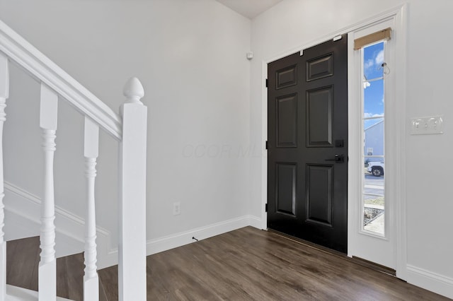 entryway with stairs, baseboards, and dark wood-style flooring