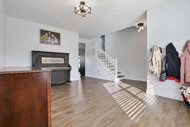 interior space featuring stairway, wood finished floors, and baseboards