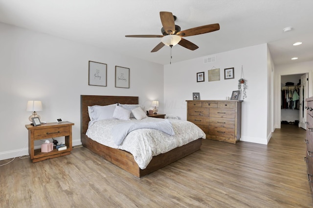 bedroom featuring recessed lighting, wood finished floors, visible vents, and baseboards