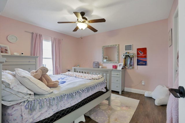 bedroom featuring wood finished floors, a ceiling fan, and baseboards