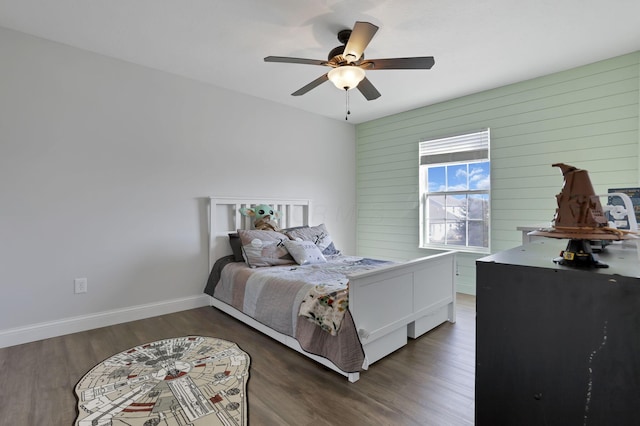 bedroom featuring ceiling fan, baseboards, and wood finished floors