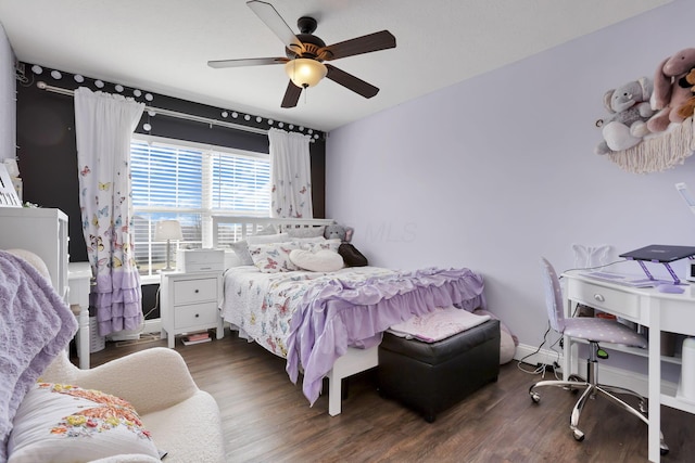 bedroom featuring baseboards, a ceiling fan, and wood finished floors