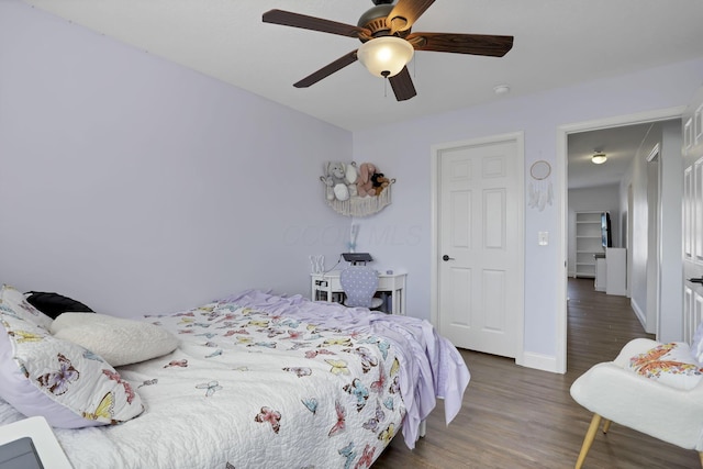 bedroom with ceiling fan, baseboards, and wood finished floors