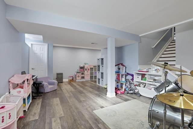 game room with baseboards, visible vents, and wood finished floors