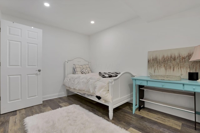 bedroom with baseboards, wood finished floors, and recessed lighting