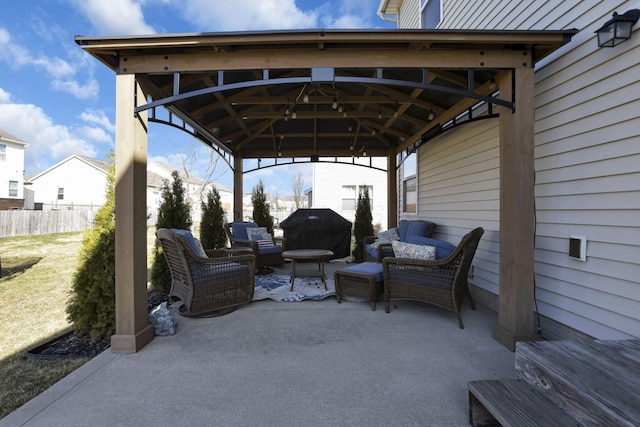 view of patio with a gazebo, outdoor lounge area, fence, and area for grilling