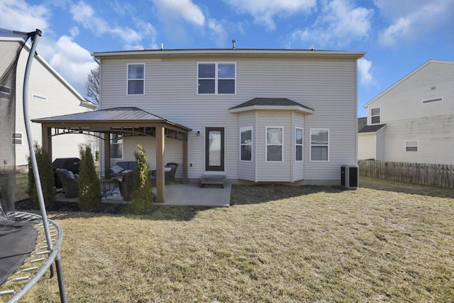 back of house with a yard, fence, a patio, and a gazebo