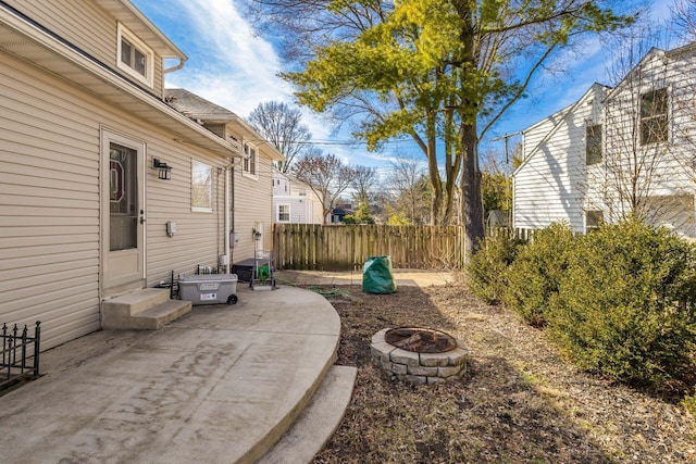 view of yard with entry steps, a fire pit, a patio area, and fence