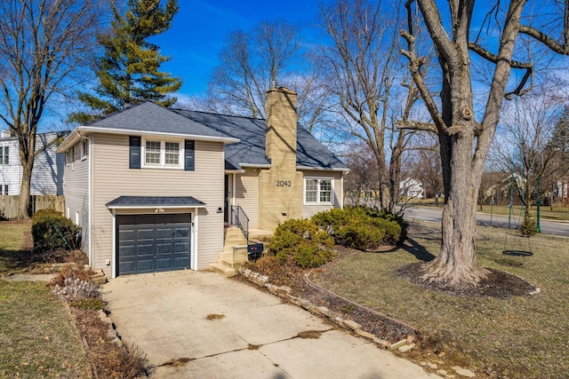 view of front facade featuring concrete driveway, a chimney, an attached garage, and roof with shingles