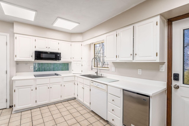 kitchen with black appliances, a sink, and white cabinets