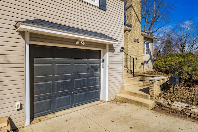 garage featuring concrete driveway