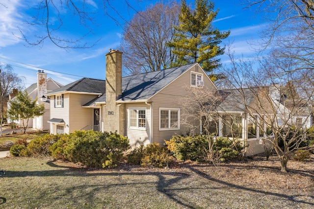 exterior space with a chimney and a sunroom