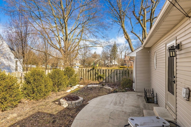 view of patio featuring fence and a fire pit