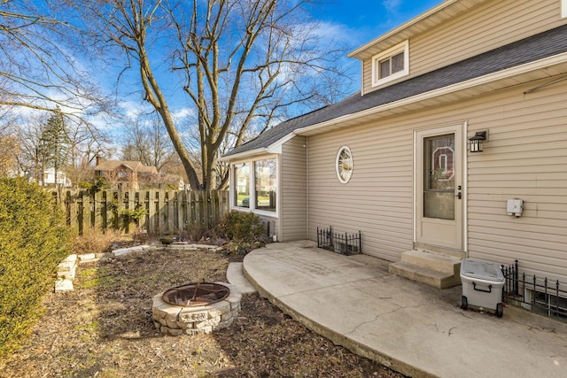 view of patio featuring entry steps, fence, and an outdoor fire pit