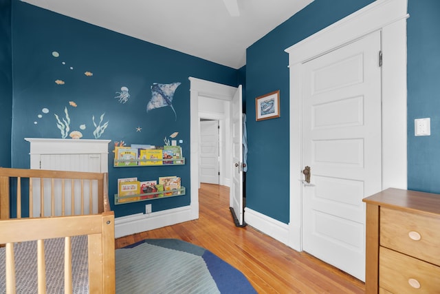 bedroom with baseboards and wood finished floors