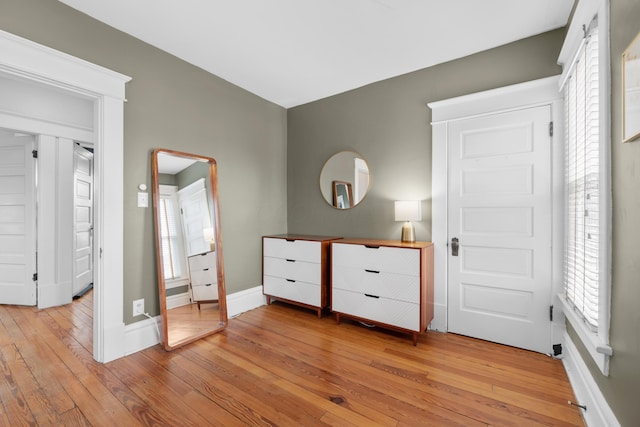 unfurnished bedroom with baseboards and light wood-style floors