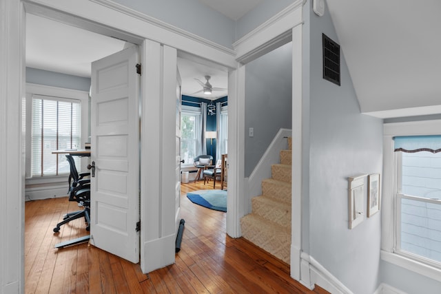 entryway featuring stairs, baseboards, visible vents, and wood-type flooring