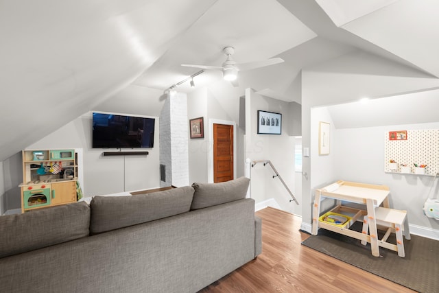 living room with visible vents, ceiling fan, vaulted ceiling, rail lighting, and wood finished floors