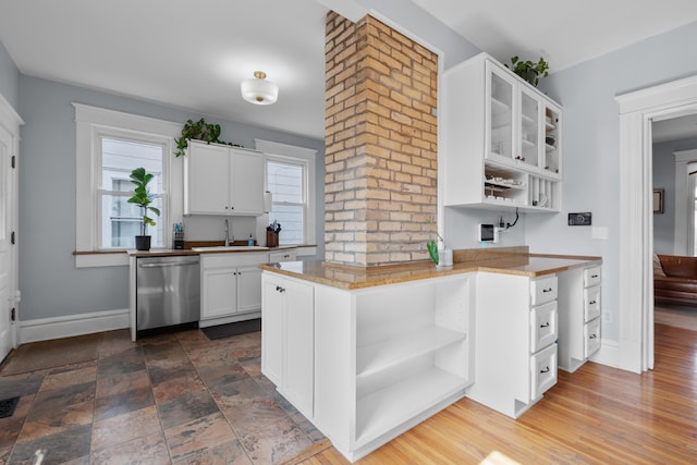 kitchen with baseboards, white cabinetry, open shelves, a sink, and dishwasher