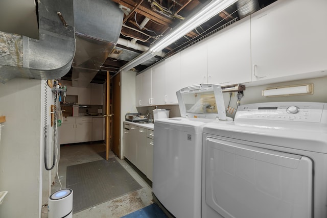 laundry room featuring cabinet space and washer and clothes dryer