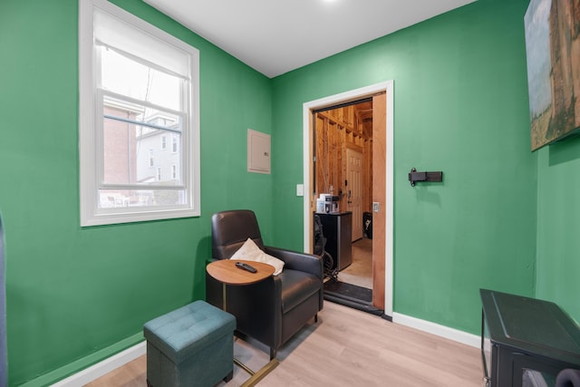 sitting room with light wood-type flooring and baseboards