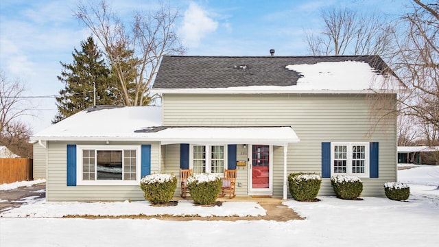 view of front of house featuring a porch and fence