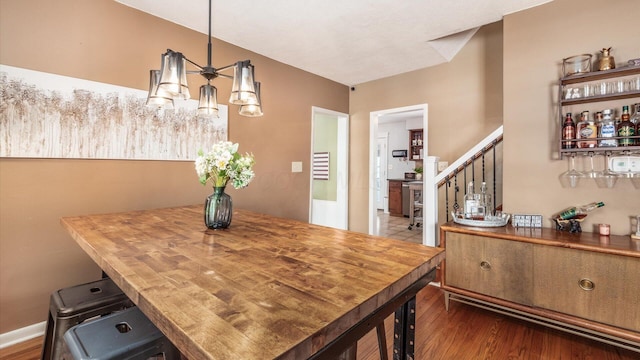 dining space featuring stairs and dark wood finished floors